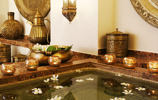 Frangipani Spa relaxation pool with candles and brass decor at Baraza Resort & Spa Zanzibar